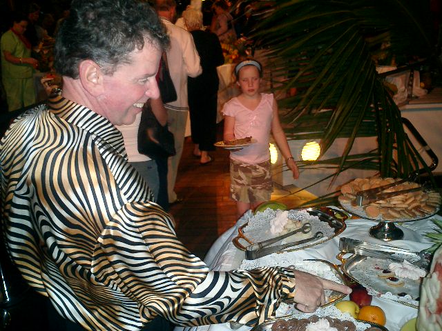 Steve gets something to eat at the buffet. Nice shirt! Click to display the image.