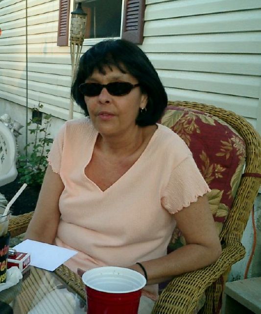 Debbie enjoys a drink.