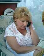 Brenda chats on the phone. Click to display the image.