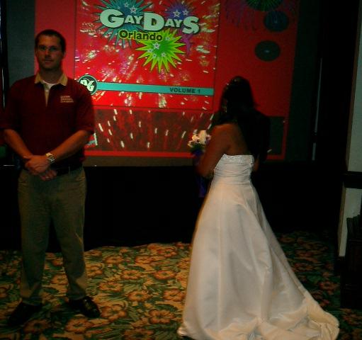 two women: one in bridal wear and one in a tuxedo.