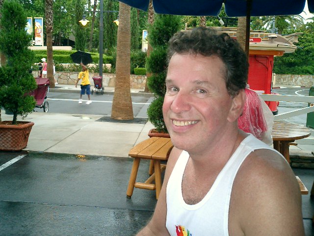 Steve smiling under umbrella.