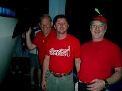 John, Jody, and Randy pose in red shirts. Click to display the image.