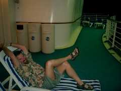 Steve relaxing at night in the back of the ship listening to the calypso band (we found them on the third day.) Click to display the image.